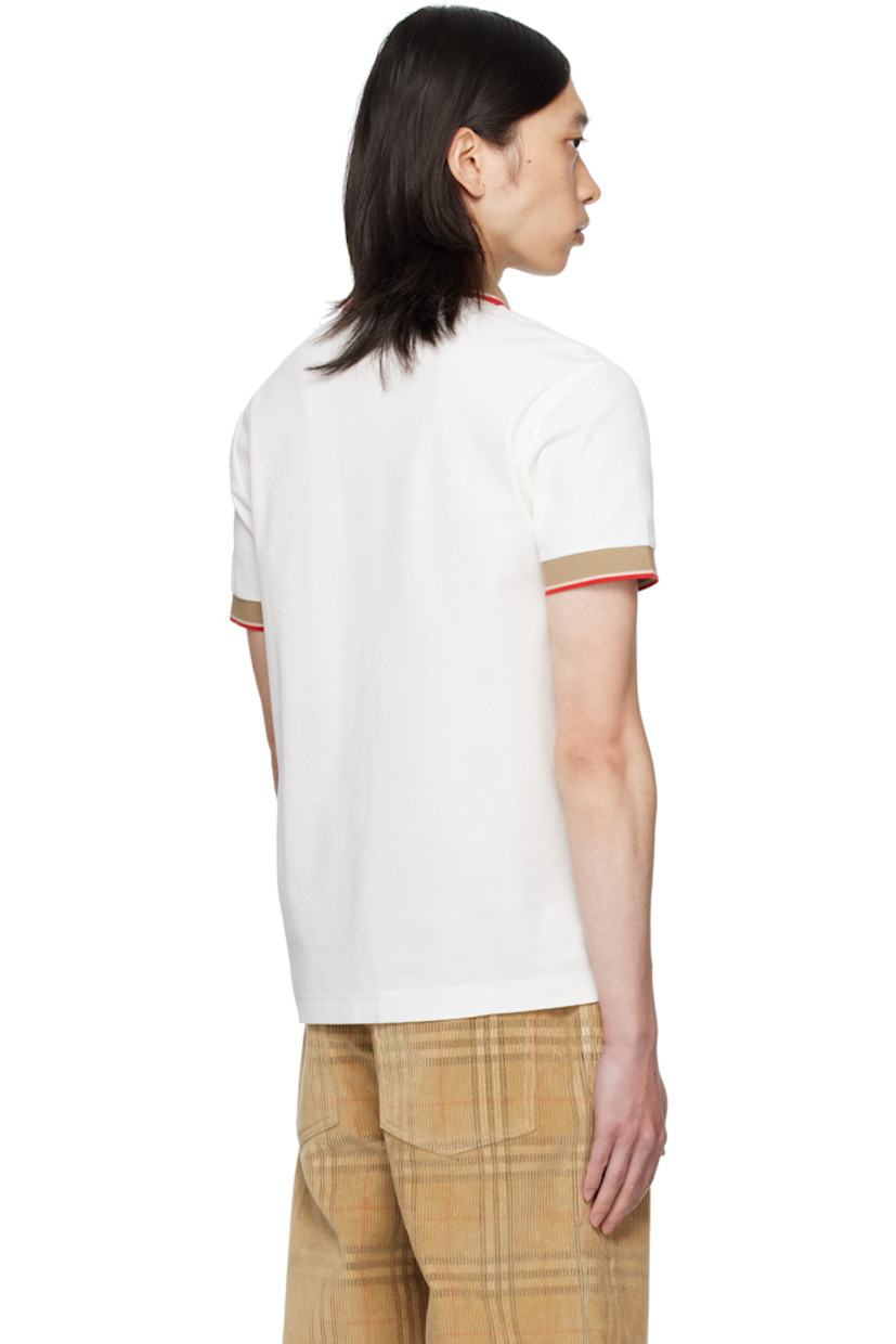 Cotton piqué polo.

· Jacquard logo at spread collar
· Stripes at collar and cuffs
· Three-button placket
· Tennis-tail hem

Supplier color: Chalk