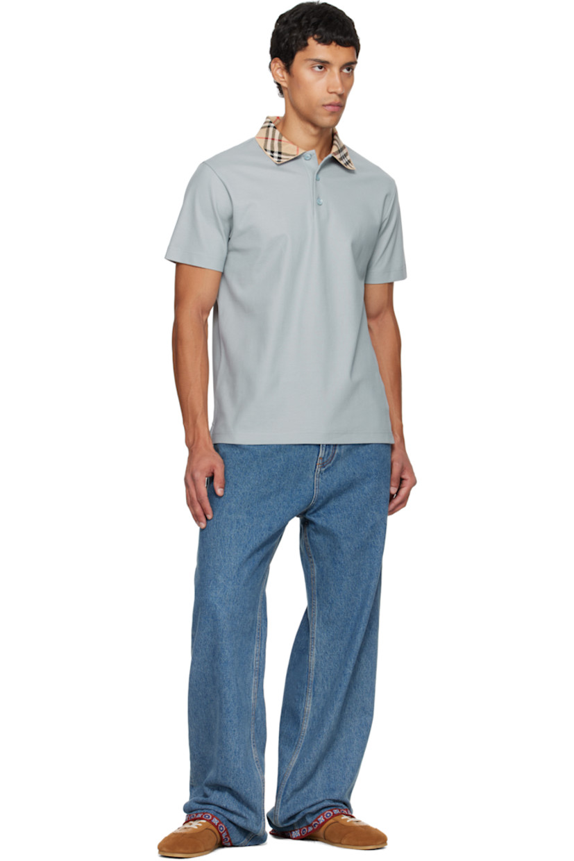 Cotton piqué polo. 

· Rib-knit spread collar 
· Jacquard signature check pattern at collar 
· Three-button placket 
· Vented side seams
· Mother-of-pearl hardware

Supplier color: Gale grey