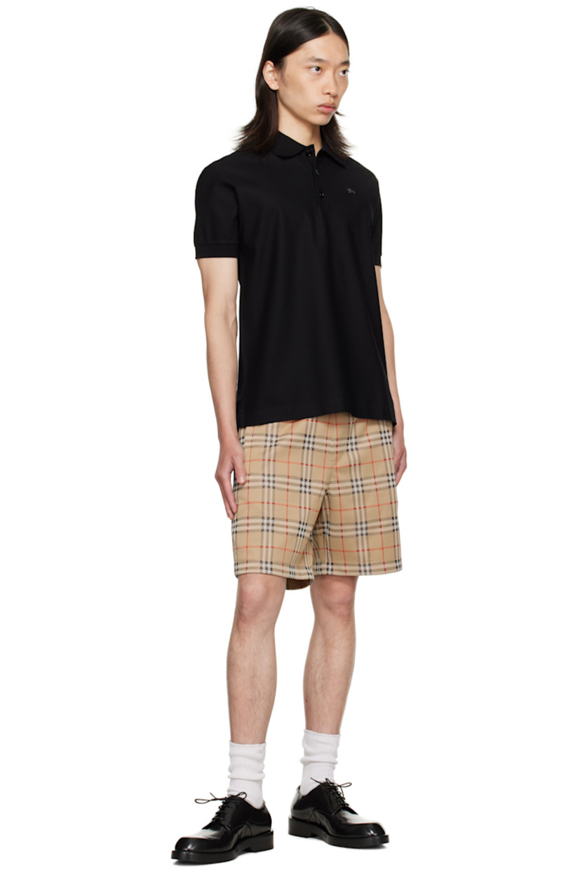 Cotton piqué polo.

· Rib-knit spread collar and cuffs
· Three-button placket
· Logo hardware at chest
· Tennis-tail hem

Supplier color: Black