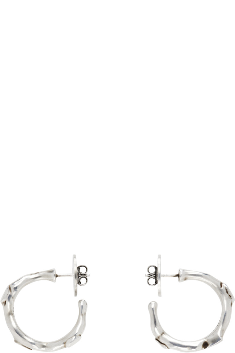 Pair of handcrafted open hoop earrings in sterling silver. 

· Textured detailing throughout
· Post-stud fastening 
· D1"

Supplier color: Antique silver