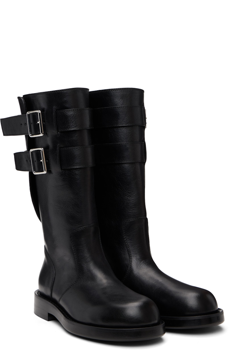 Mid-calf grained calfskin boots.

· Rivet and pin-buckle straps at collar 
· Stacked leather midsole and block heel
· Suede sole with rubber injection

Supplier color: Black