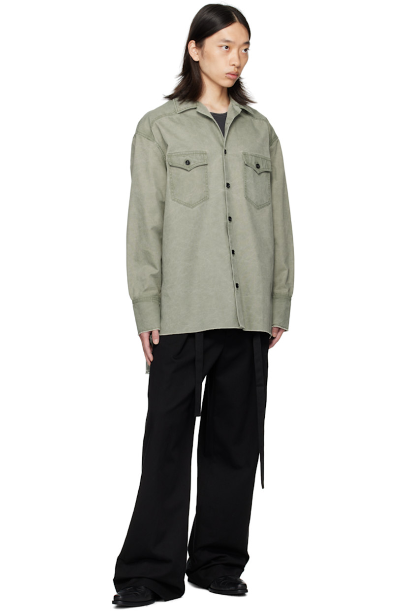 Cotton canvas shirt. 

· Spread collar
· Button closure
· Flap pockets at chest
· Droptail hem
· Raw edge at hem and cuffs
· Buttoned barrel cuffs
· Western-style back yoke

Supplier color: Sage