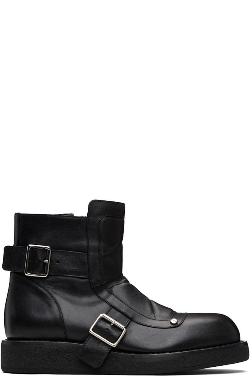 Ankle-high grained leather boots.

· Quilted and padded tongue 
· Zip closure at inner side
· Rivets and pin-buckle straps at outer side
· Crêpe rubber sole 

Supplier color: Black
