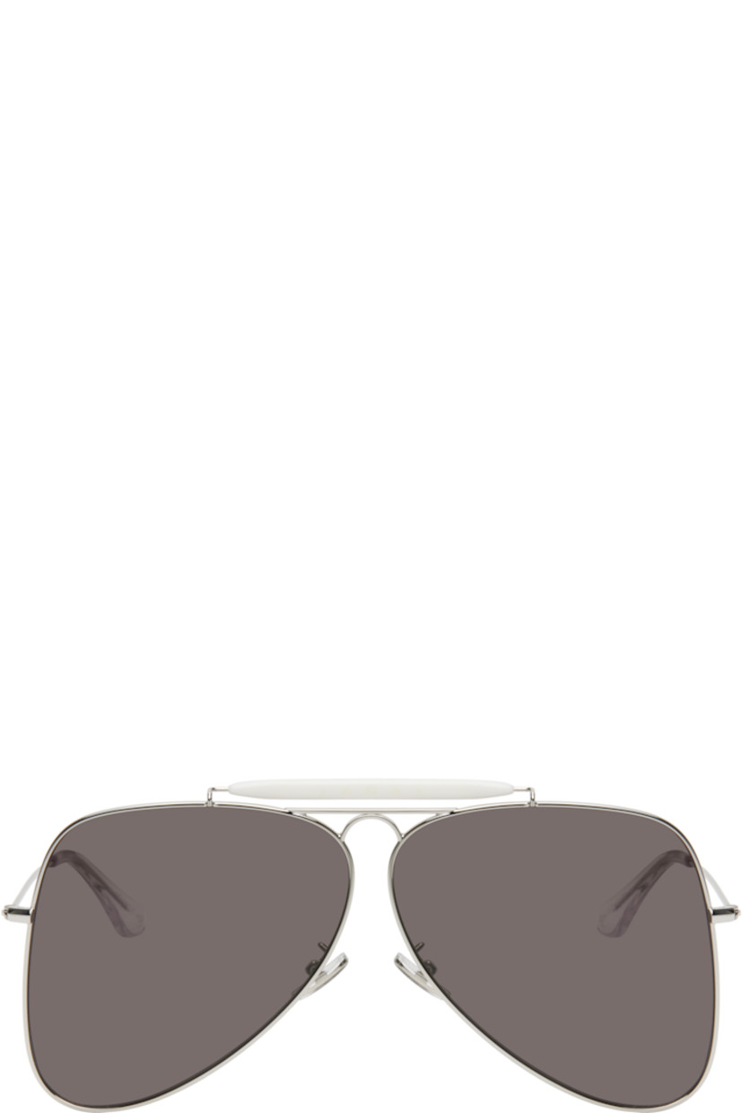 Aviator-style metal-frame sunglasses in silver tone.

· Handcrafted
· Gray lenses
· 100% UVA/UVB protection, category 3
· Adjustable rubber nose pads
· Double bridge
· Logo engraved at top bar
· Transparent acetate temple tips
· Includes pouch
· Size: 67.07 145

Supplier color: Silver