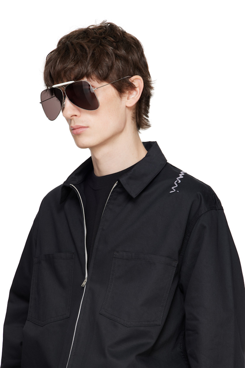 Aviator-style metal-frame sunglasses in silver tone.

· Handcrafted
· Gray lenses
· 100% UVA/UVB protection, category 3
· Adjustable rubber nose pads
· Double bridge
· Logo engraved at top bar
· Transparent acetate temple tips
· Includes pouch
· Size: 67.07 145

Supplier color: Silver