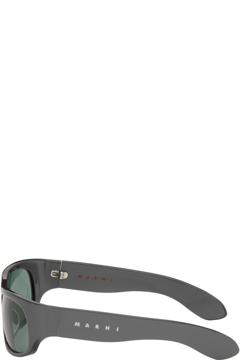 Handcrafted wraparound acrylic-frame sunglasses in gray.

· Blue lenses
· Integrated nose pads
· Logo etched at temples 
· Includes pouch
· Size: 62.17 125

Supplier color: Solid grey