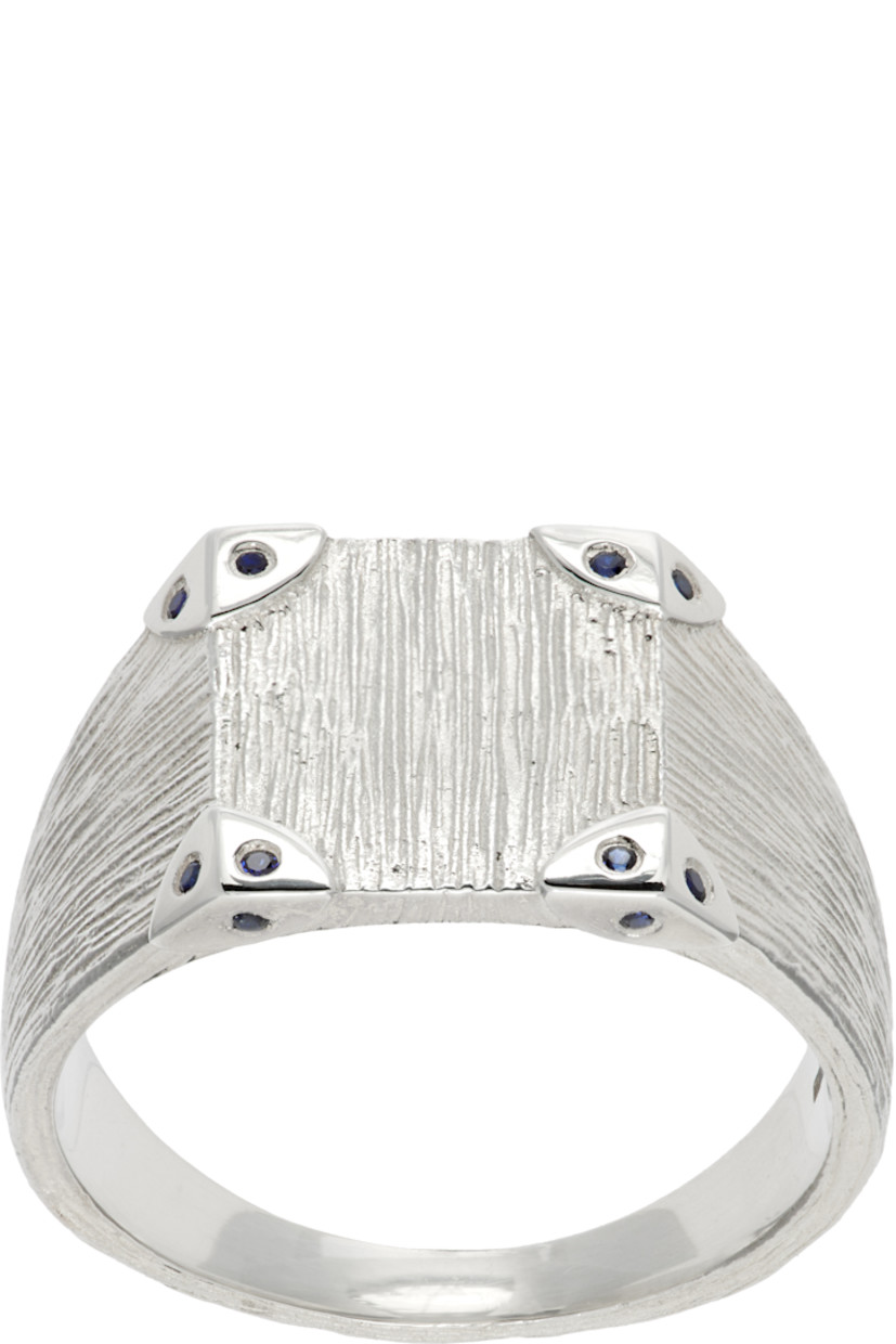 Handcrafted textured signet ring in sterling silver. 

· Blue lab-grown sapphires at face 
· Logo and full hallmarking at inner band 

Supplier color: Silver