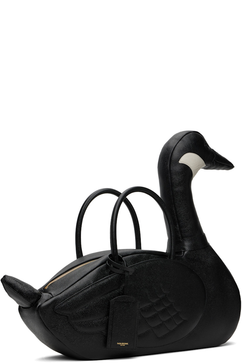 Structured pebble-grained calfskin top handle bag.

· Rolled carry handles with detachable ID holder
· Padded graphic with tricolor loop at side
· Patch compartment at quilted wings
· Zip closure
· Zip pocket at interior
· Tricolor grosgrain lining
· H8" x W17" x D5"
· Total height: H18"

Supplier color: Black