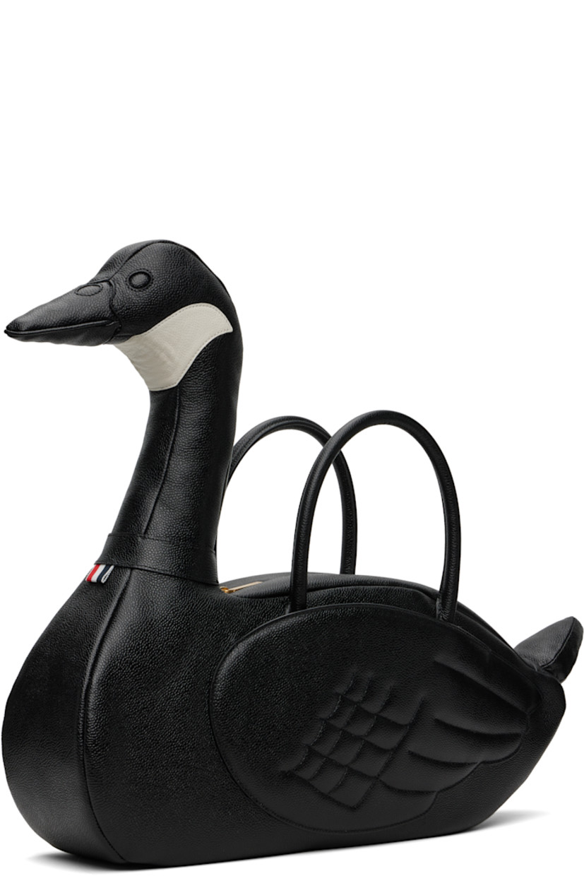 Structured pebble-grained calfskin top handle bag.

· Rolled carry handles with detachable ID holder
· Padded graphic with tricolor loop at side
· Patch compartment at quilted wings
· Zip closure
· Zip pocket at interior
· Tricolor grosgrain lining
· H8" x W17" x D5"
· Total height: H18"

Supplier color: Black