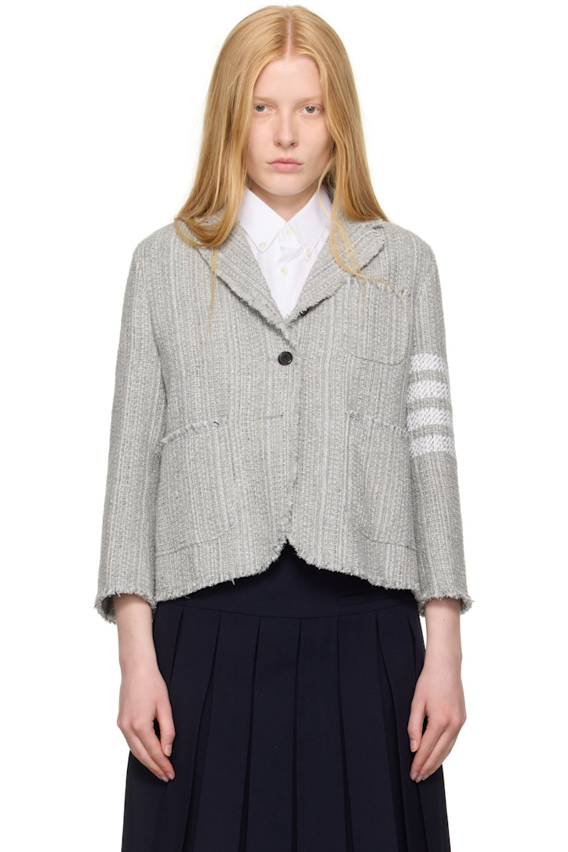 Cotton-blend tweed blazer. Frayed edges throughout.

· Notched lapel
· Button closure
· Patch pockets at front 
· Stripes at sleeve
· Buttoned surgeon's cuffs
· Tricolor grosgrain flag at back collar
· Central vent at back hem
· Welt pockets at interior 
· Full plain-woven silk lining

Supplier color: Med grey