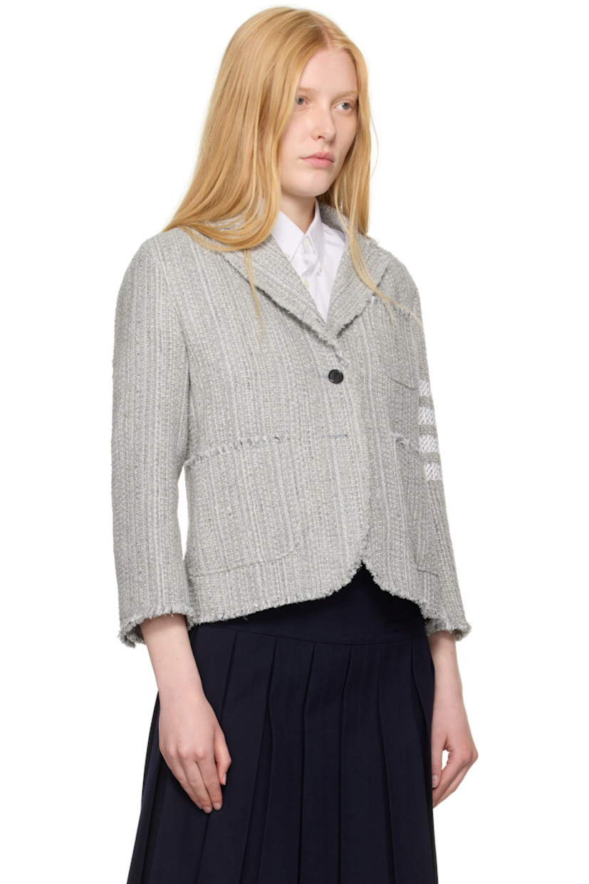 Cotton-blend tweed blazer. Frayed edges throughout.

· Notched lapel
· Button closure
· Patch pockets at front 
· Stripes at sleeve
· Buttoned surgeon's cuffs
· Tricolor grosgrain flag at back collar
· Central vent at back hem
· Welt pockets at interior 
· Full plain-woven silk lining

Supplier color: Med grey