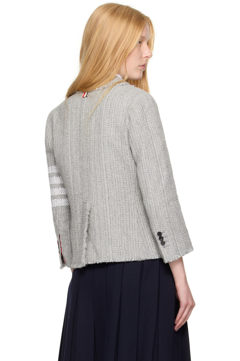 Cotton-blend tweed blazer. Frayed edges throughout.

· Notched lapel
· Button closure
· Patch pockets at front 
· Stripes at sleeve
· Buttoned surgeon's cuffs
· Tricolor grosgrain flag at back collar
· Central vent at back hem
· Welt pockets at interior 
· Full plain-woven silk lining

Supplier color: Med grey