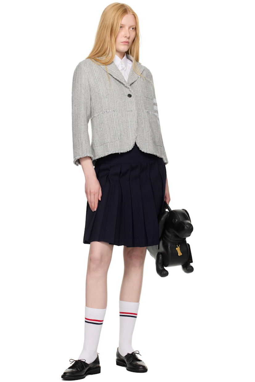 Cotton-blend tweed blazer. Frayed edges throughout.

· Notched lapel
· Button closure
· Patch pockets at front 
· Stripes at sleeve
· Buttoned surgeon's cuffs
· Tricolor grosgrain flag at back collar
· Central vent at back hem
· Welt pockets at interior 
· Full plain-woven silk lining

Supplier color: Med grey