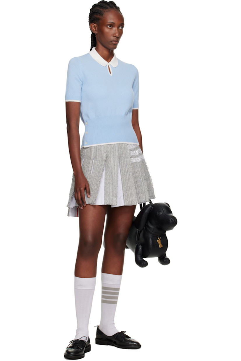 Cotton-blend tweed miniskirt. 

· Stripes at poplin panels
· Pleats and raw edges throughout 
· Button tab at waistband
· Stripes at side seam
· Tricolor grosgrain trim at interior 
· Tricolor grosgrain flag at back waist
· Silk crêpe lining

Supplier color: Med grey
