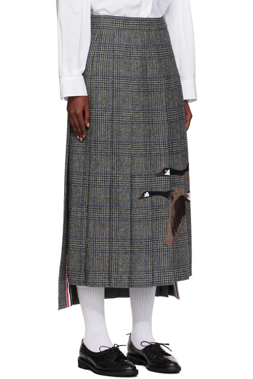 Wool tweed maxi skirt. 

· Prince of Wales pattern and pleats throughout 
· Embroidered graphic appliqués at front 
· Tricolor grosgrain trim at vented droptail hem 
· Button tab and concealed zip closure at side seam
· Tricolor grosgrain flag at back waistband
· Full satin lining 

Supplier color: Med grey