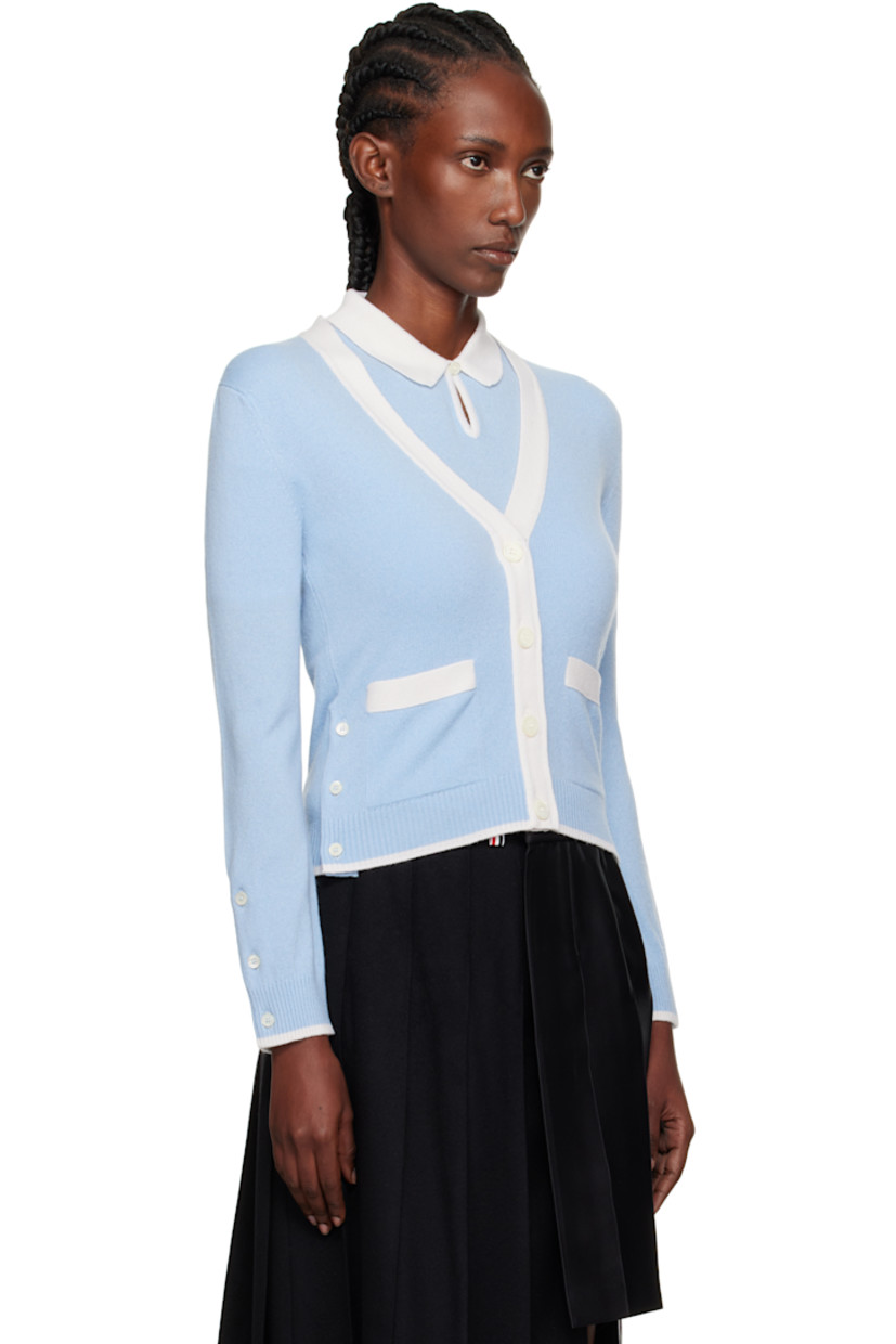 Knit cashmere cardigan.

· Concealed tricolor grosgrain trim throughout
· Rib-knit Y-neck, hem, and cuffs
· Button closure
· Patch pockets
· Button vent at side seams and cuffs
· Tricolor grosgrain flag at back collar

Supplier color: Light Blue