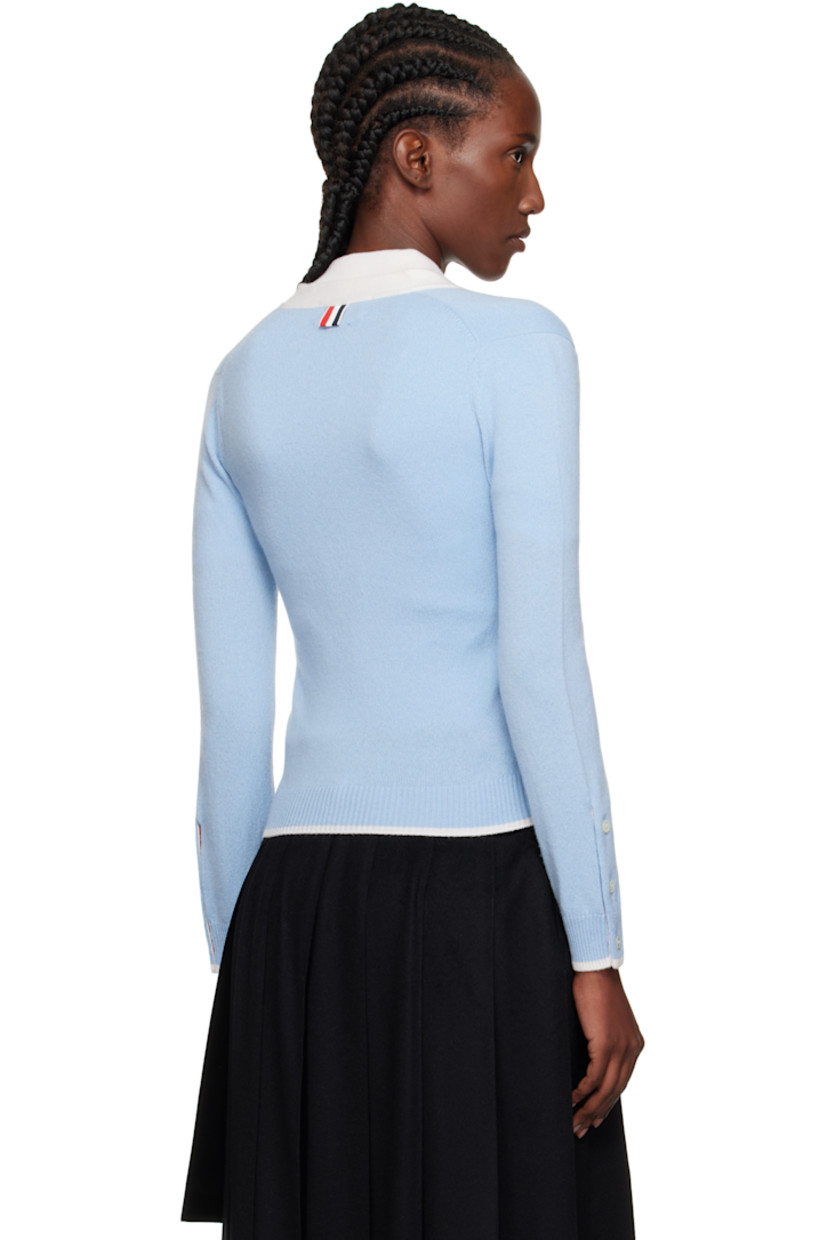 Knit cashmere cardigan.

· Concealed tricolor grosgrain trim throughout
· Rib-knit Y-neck, hem, and cuffs
· Button closure
· Patch pockets
· Button vent at side seams and cuffs
· Tricolor grosgrain flag at back collar

Supplier color: Light Blue