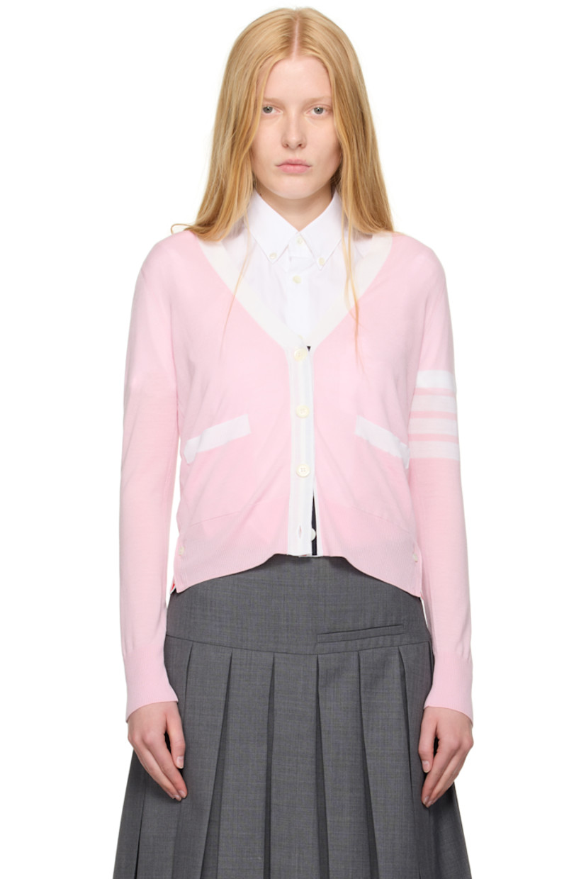 Knit virgin wool cardigan. Concealed tricolor grosgrain trim throughout.

· Rib-knit Y-neck, hem, and cuffs
· Button closure
· Patch pockets
· Button vent at side seams and cuffs
· Stripes at sleeve
· Tricolor grosgrain flag at back collar

Supplier color: Light pink