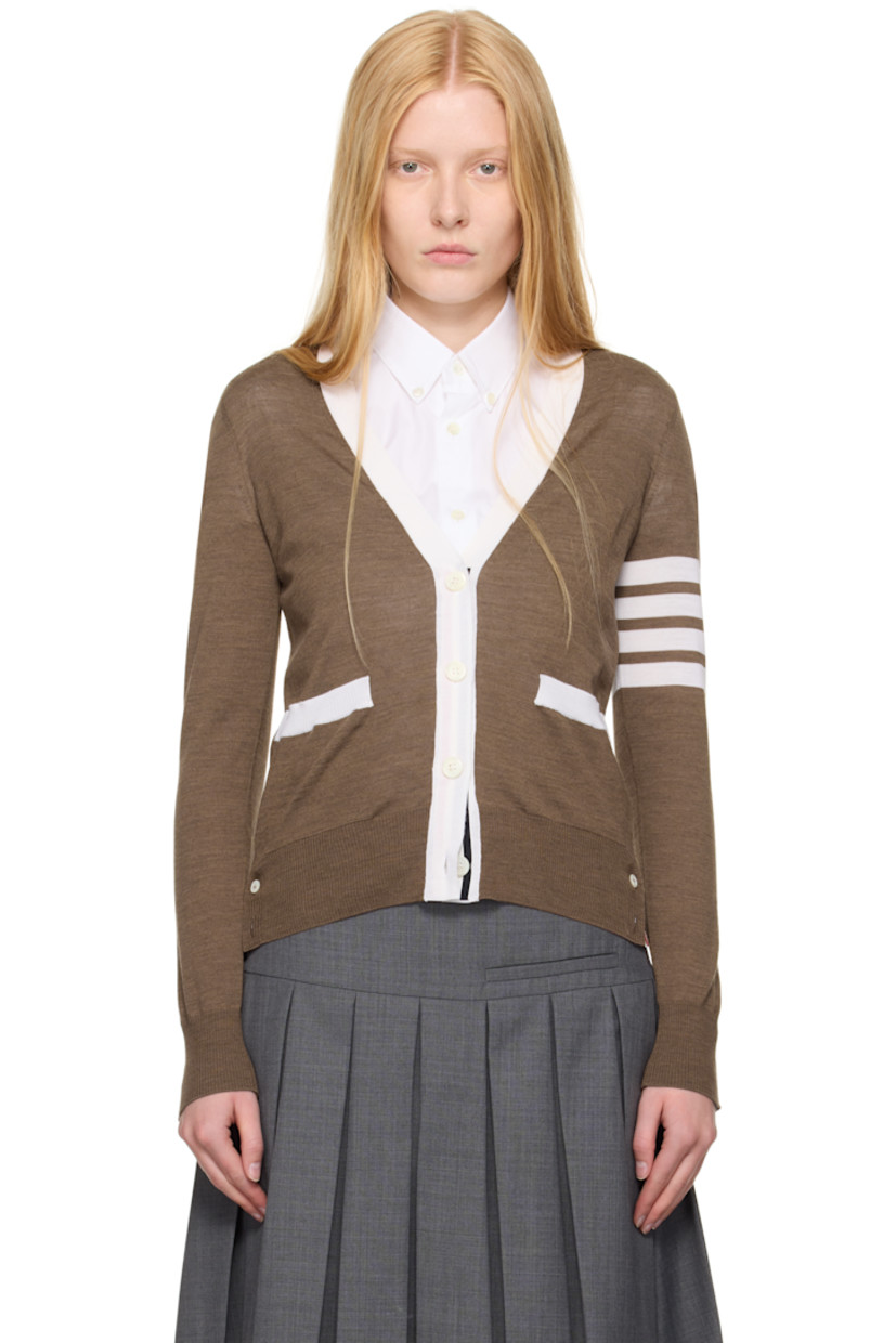 Knit virgin wool cardigan. Concealed tricolor grosgrain trim throughout.

· Rib-knit Y-neck, hem, and cuffs
· Button closure
· Patch pockets
· Button vent at side seams and cuffs
· Stripes at sleeve
· Tricolor grosgrain flag at back collar

Supplier color: Walnut