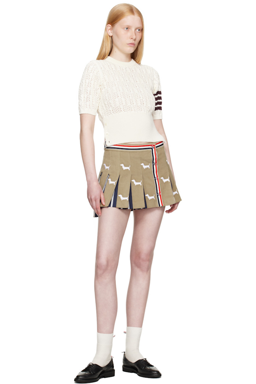 Pointelle-knit cotton sweater. Cable-knit detailing throughout.

· Rib-knit crewneck, hem, and cuffs
· Button vent at side seams with tricolor grosgrain trim
· Intarsia stripes at sleeve
· Tricolor grosgrain flag at back collar

Supplier color: White