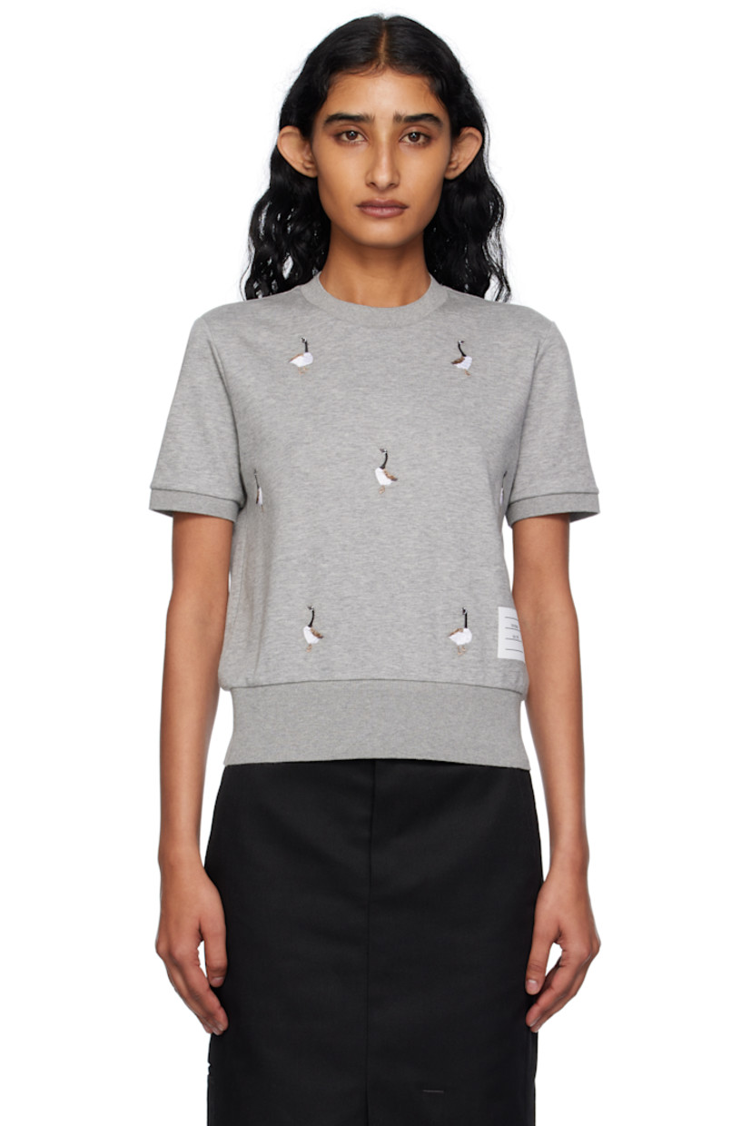 Cotton jersey T-shirt.

· Embroidered graphic pattern throughout
· Rib-knit crewneck, hem, and cuffs
· Logo patch at front hem 
· Tricolor loop at back collar

Supplier color: Lt grey