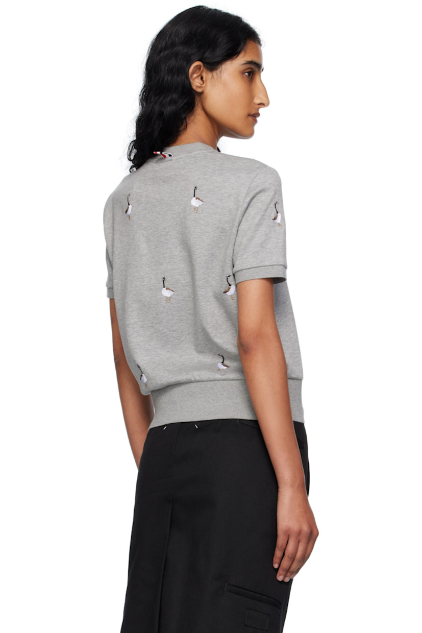 Cotton jersey T-shirt.

· Embroidered graphic pattern throughout
· Rib-knit crewneck, hem, and cuffs
· Logo patch at front hem 
· Tricolor loop at back collar

Supplier color: Lt grey