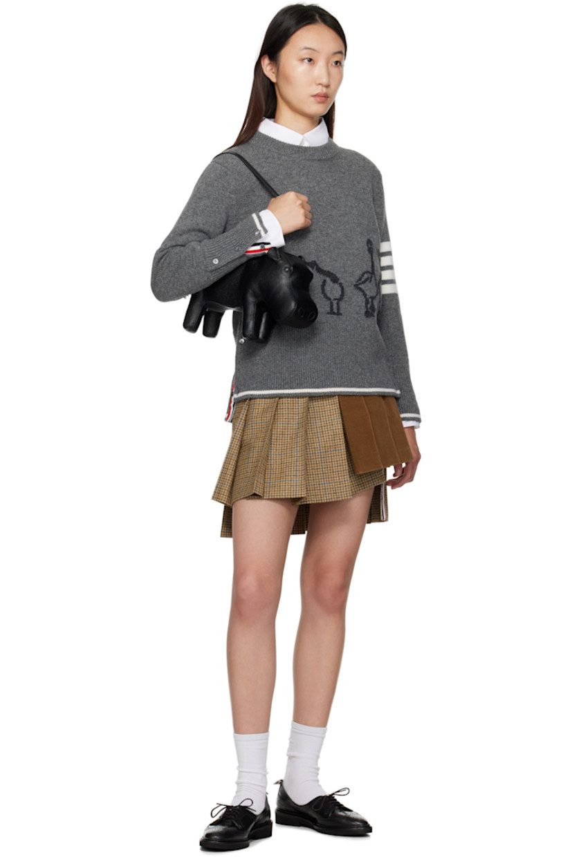 Knit virgin wool sweater.

· Rib-knit crewneck, hem, and cuffs
· Intarsia graphic at front
· Intarsia stripes at sleeve
· Buttoned vent at hem
· Tricolor loop at back collar
· Intarsia stripe at hem and cuffs

Supplier color: Med Grey