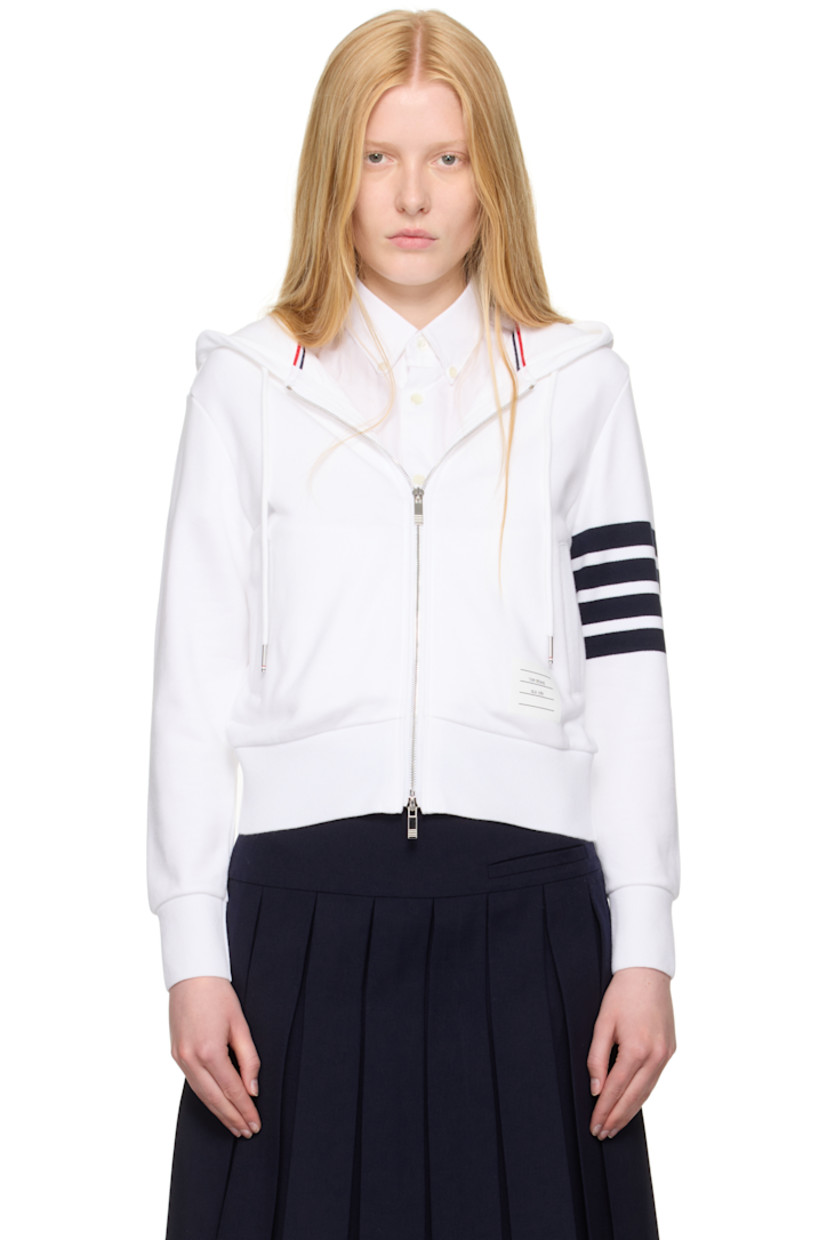 French terry hoodie. 

· Drawstring at hood
· Rib-knit hood, hem, and cuffs
· Two-way zip closure 
· Welt pockets
· Logo patch at front  
· Stripes at sleeve
· Tricolor grosgrain flag at back collar

Supplier color: White/Navy