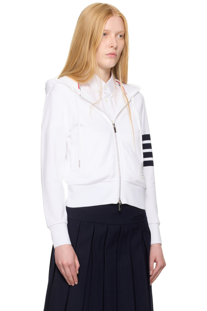 French terry hoodie. 

· Drawstring at hood
· Rib-knit hood, hem, and cuffs
· Two-way zip closure 
· Welt pockets
· Logo patch at front  
· Stripes at sleeve
· Tricolor grosgrain flag at back collar

Supplier color: White/Navy