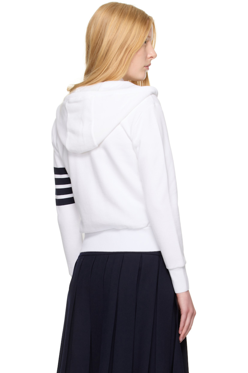 French terry hoodie. 

· Drawstring at hood
· Rib-knit hood, hem, and cuffs
· Two-way zip closure 
· Welt pockets
· Logo patch at front  
· Stripes at sleeve
· Tricolor grosgrain flag at back collar

Supplier color: White/Navy