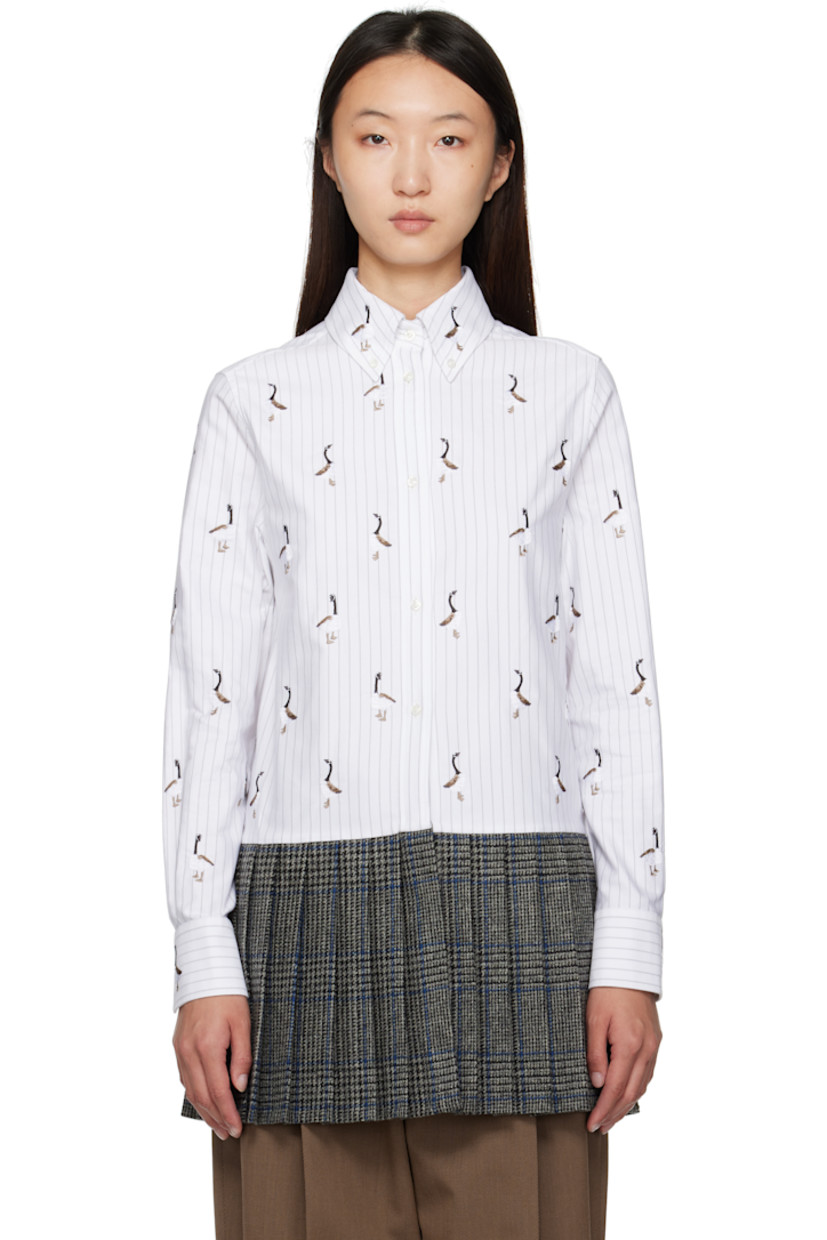 Cotton poplin shirt.

· Check and embroidered graphic pattern throughout
· Paneled construction with knit wool hem
· Spread collar 
· Button closure
· Tricolor loop at back collar
· Buttoned barrel cuffs

Supplier Color: Grey