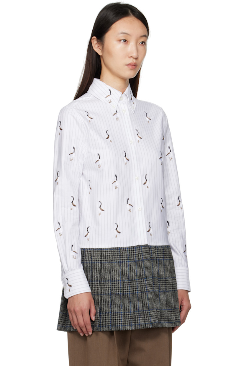 Cotton poplin shirt.

· Check and embroidered graphic pattern throughout
· Paneled construction with knit wool hem
· Spread collar 
· Button closure
· Tricolor loop at back collar
· Buttoned barrel cuffs

Supplier Color: Grey