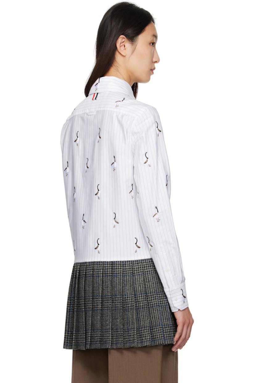 Cotton poplin shirt.

· Check and embroidered graphic pattern throughout
· Paneled construction with knit wool hem
· Spread collar 
· Button closure
· Tricolor loop at back collar
· Buttoned barrel cuffs

Supplier Color: Grey