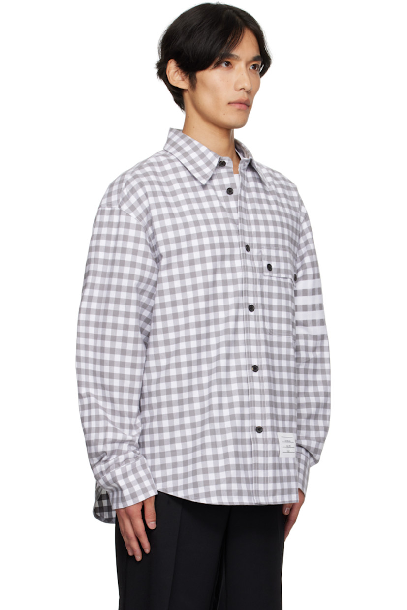 Cotton flannel shirt. 

· Gingham pattern printed throughout 
· Spread collar 
· Button closure
· Flap pocket at waist 
· Logo patch at front hem
· Shirttail hem
· Dropped shoulders
· Buttoned barrel cuffs
· Tricolor grosgrain flag at back collar 
· Locker loop and twin pleats at back yoke 

Supplier color: Med grey