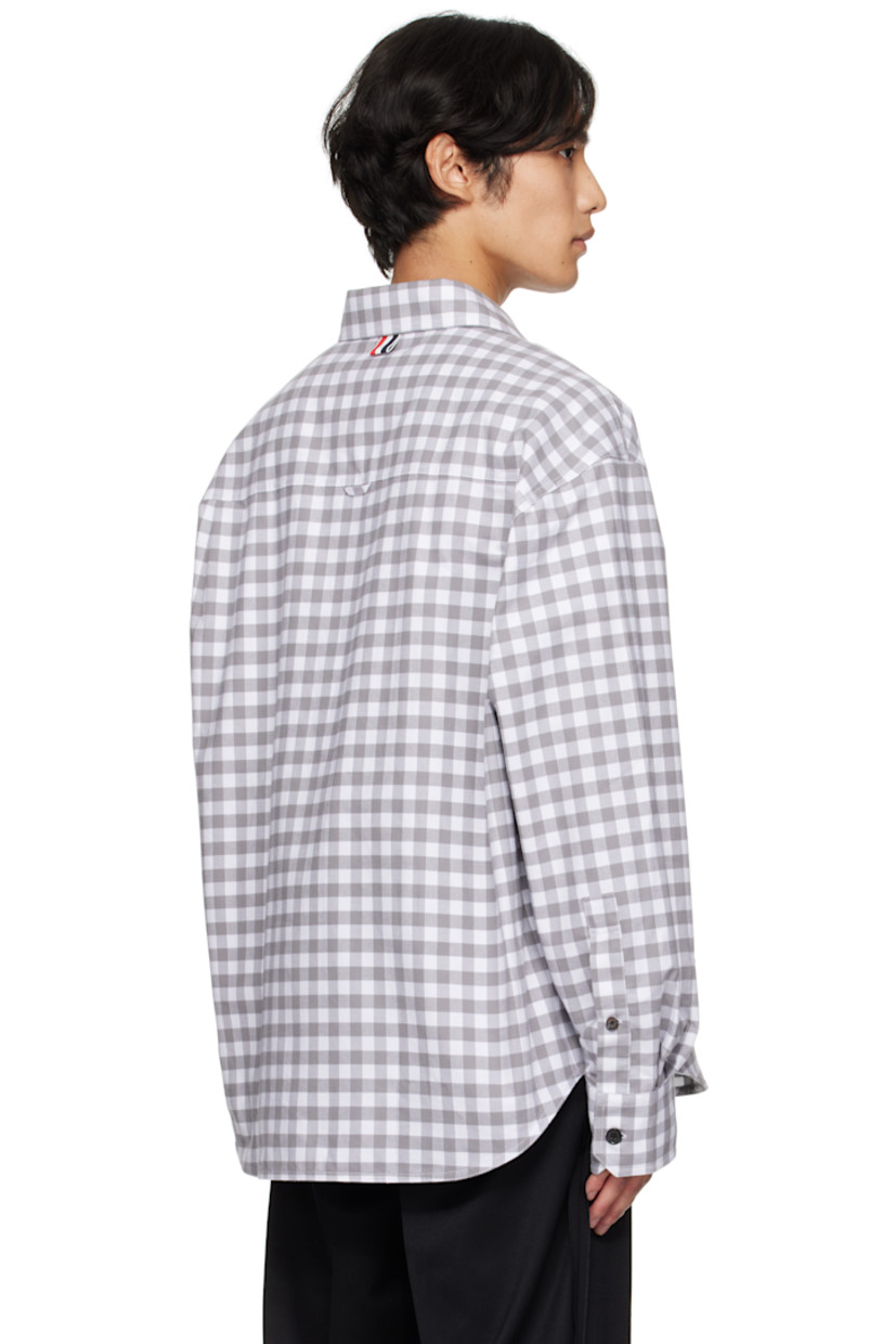 Cotton flannel shirt. 

· Gingham pattern printed throughout 
· Spread collar 
· Button closure
· Flap pocket at waist 
· Logo patch at front hem
· Shirttail hem
· Dropped shoulders
· Buttoned barrel cuffs
· Tricolor grosgrain flag at back collar 
· Locker loop and twin pleats at back yoke 

Supplier color: Med grey