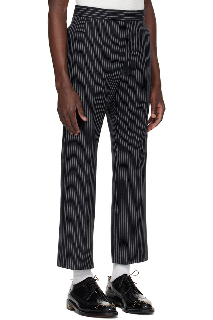 Wool tweed trousers. 

· Pinstripes throughout
· Four-pocket styling
· Button fly
· Creased legs
· Adjustable button strap and tricolor grosgrain flag at back
· Full cupro satin lining

Supplier color: Navy