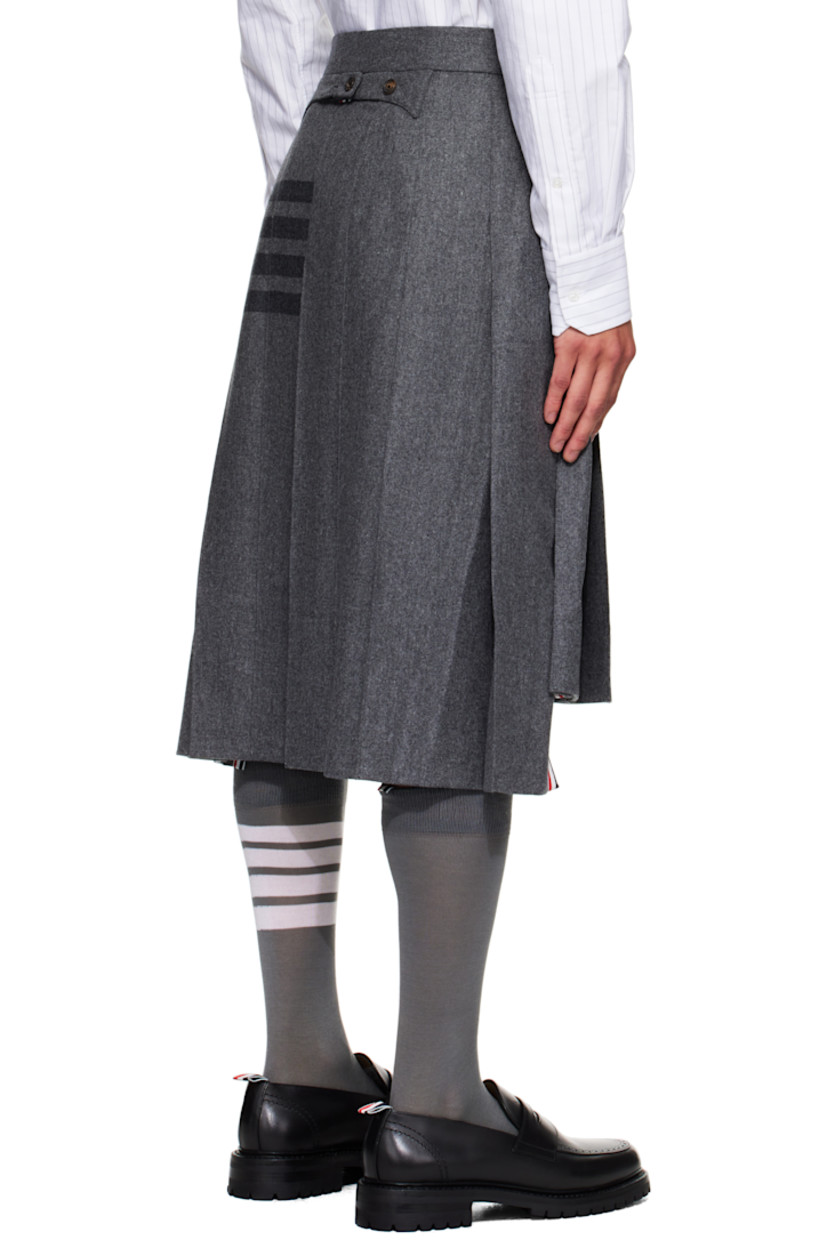 Felted wool-blend flannel skirt.

· Knife pleats throughout
· Button fly
· Droptail hem
· Stripes printed at side
· Tricolor grosgrain trim at vented side seams
· Tricolor grosgrain flag and adjustable button tab at back
· Full cupro satin lining

Supplier color: Med grey