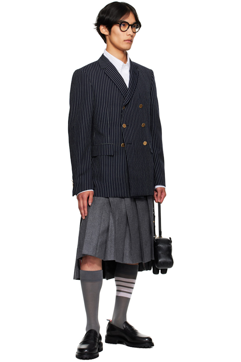 Felted wool-blend flannel skirt.

· Knife pleats throughout
· Button fly
· Droptail hem
· Stripes printed at side
· Tricolor grosgrain trim at vented side seams
· Tricolor grosgrain flag and adjustable button tab at back
· Full cupro satin lining

Supplier color: Med grey