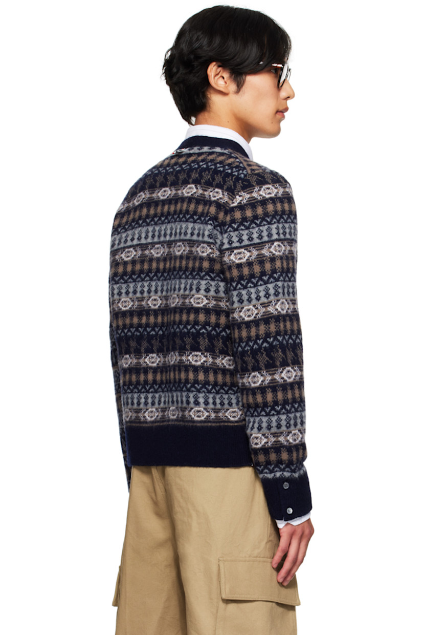 Brushed knit wool cardigan.

· Jacquard graphic pattern throughout
· Tricolor trim at placket and vents
· V-neck
· Button closure
· Patch pockets at waist
· Rib-knit hem and cuffs
· Button vent at side seams and cuffs
· Tricolor grosgrain flag at back collar

Supplier color: Navy