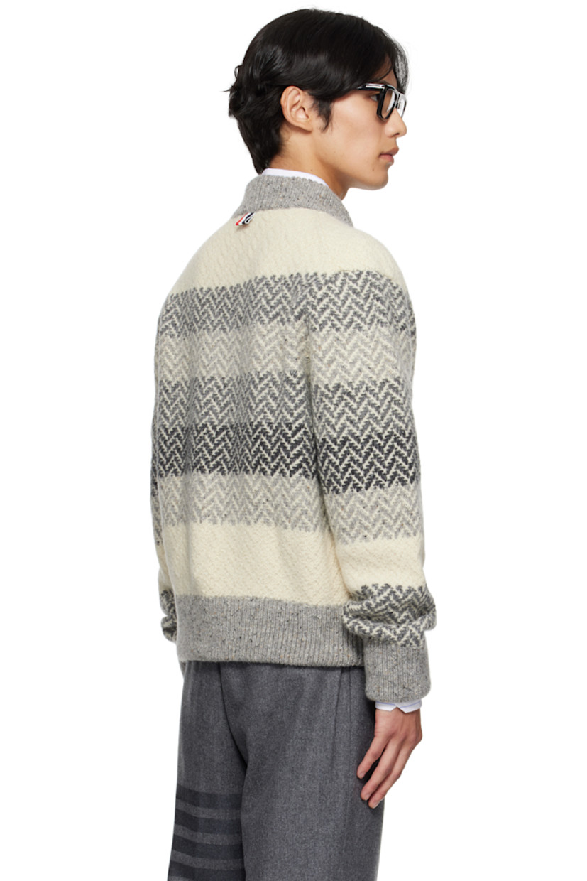 Brushed knit wool- and mohair-blend sweater.

· Jacquard stripes and herringbone pattern throughout
· Rib-knit stand collar, hem, and cuffs
· Two-way zip closure
· Welt pockets
· Tricolor grosgrain flag at back collar

Supplier color: Tonal grey