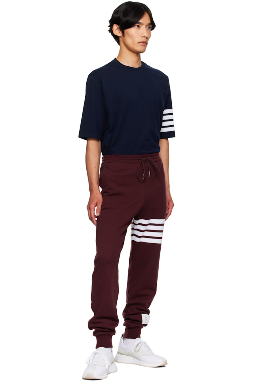 Cotton French terry sweatpants.

· Drawstring at elasticized waistband
· Three-pocket styling
· Intarsia stripes at leg
· Logo patch at lower leg
· Rib-knit cuffs
· Tricolor grosgrain flag at back waistband

Supplier color: Burgundy