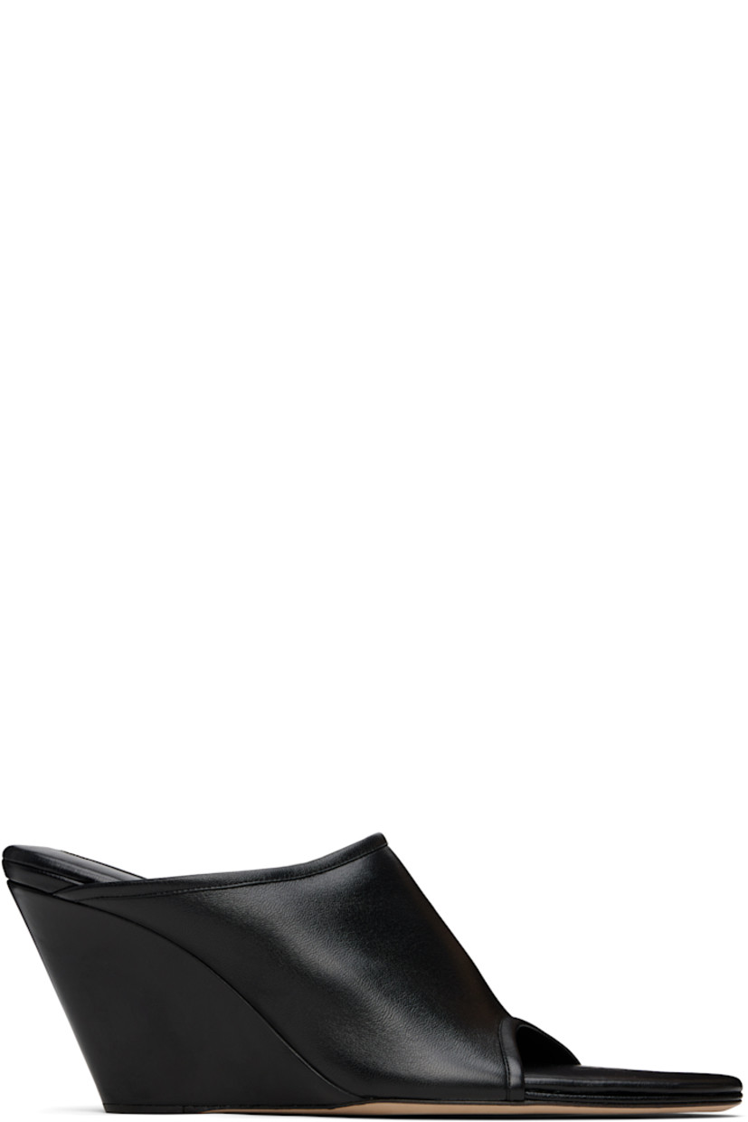 Grained lambskin mules in black. 

· Open almond toe
· Logo patch at padded kidskin footbed
· Jersey lining
· Covered wedge heel 
· Calfskin nubuck sole with rubber injection
· Heel: H3"

Supplier color: Black