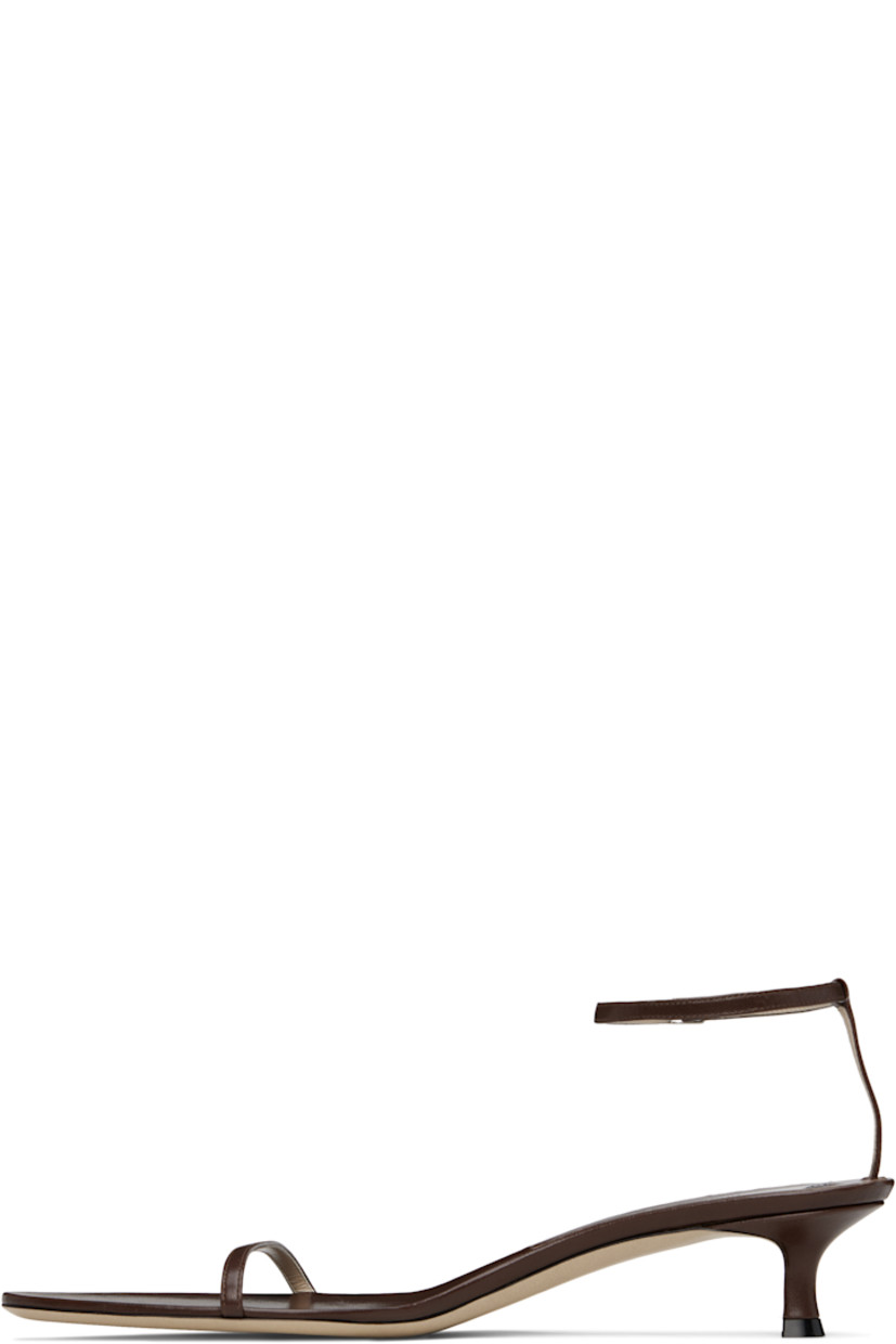 Grained lambskin heeled sandals in brown.

· Open almond toe
· Pin-buckle ankle strap
· Logo patch at footbed
· Covered kitten heel with rubber injection
· Grained calfskin sole
· Heel: H1.75"

Supplier color: Forest brown