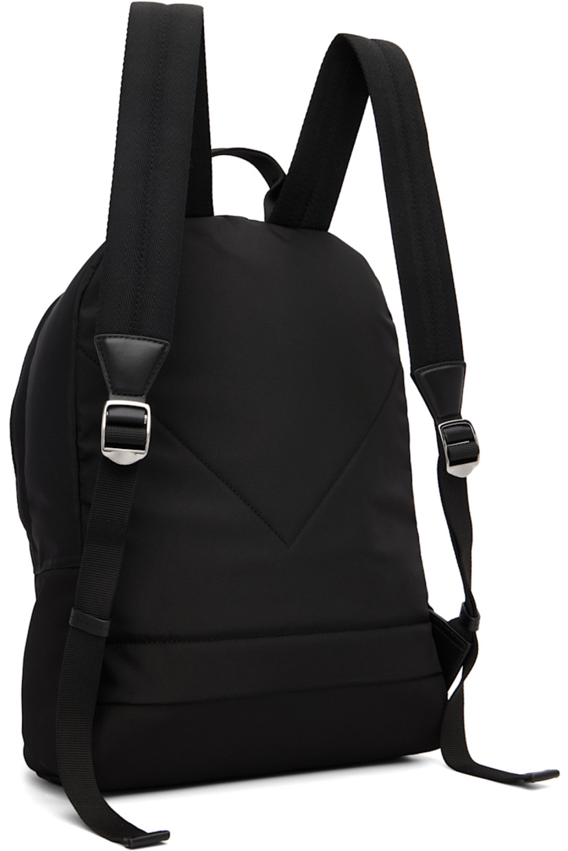 Canvas backpack.

· Fixed carry handle
· Adjustable padded shoulder straps
· Embroidered logo graphic and zip pocket at face
· Two-way zip closure
· Patch pocket at interior
· Twill lining
· H16" x W15" x D5.5"

Supplier color: Black