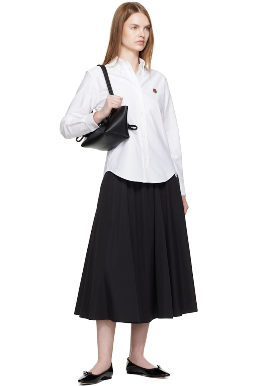 Cotton oxford cloth shirt. 

· Button-down spread collar 
· Button closure
· Embroidered logo at chest
· Shirttail hem
· Buttoned barrel cuffs
· Logo embroidered at back collar 
· Box pleat at back yoke 

Supplier color: White
