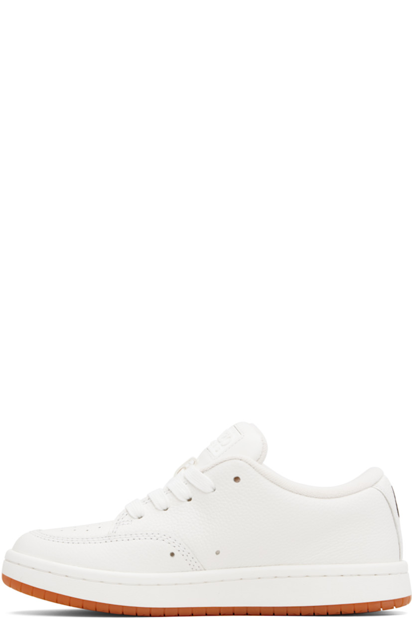 Low-top grained leather sneakers.

· Perforated detailing at toe and inner side
· Lace-up closure
· Rubberized logo patch at padded tongue
· Padded collar
· Logo appliqué at heel tab
· Terrycloth lining
· Treaded rubber sole
· Includes alternate laces in blue

Supplier color: Off white