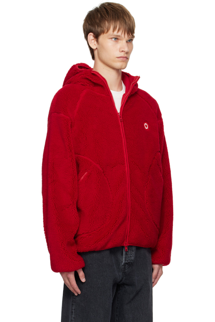 Sherpa fleece jacket.

· Hood at stand collar
· Two-way zip closure
· Logo graphic patch at chest
· Zip pockets at front
· Elasticized hem and cuffs
· Dropped shoulders
· Full mesh lining

Supplier color: Medium red