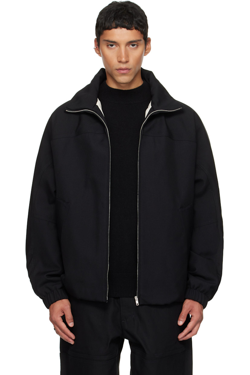 Padded virgin wool twill jacket.

· Stand collar
· Zip closure
· Press-stud welt pockets at waist
· Partially elasticized hem
· Yoke sleeves
· Elasticized cuffs
· Striped webbing strap at back collar
· Full satin twill lining

Supplier color: Black