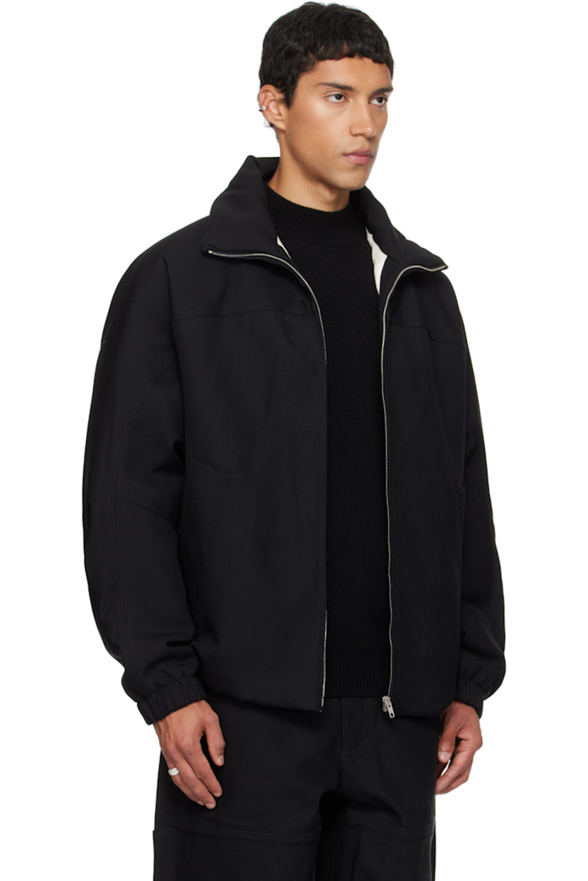 Padded virgin wool twill jacket.

· Stand collar
· Zip closure
· Press-stud welt pockets at waist
· Partially elasticized hem
· Yoke sleeves
· Elasticized cuffs
· Striped webbing strap at back collar
· Full satin twill lining

Supplier color: Black