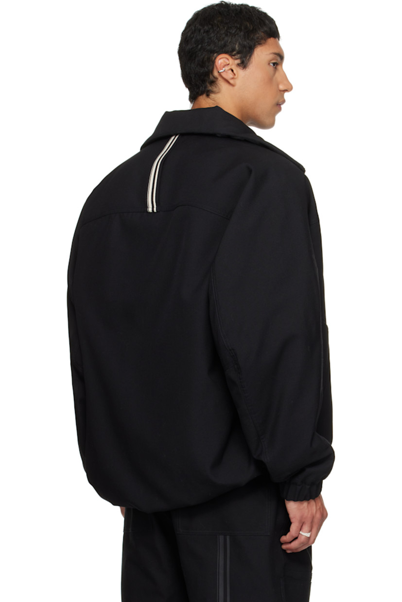 Padded virgin wool twill jacket.

· Stand collar
· Zip closure
· Press-stud welt pockets at waist
· Partially elasticized hem
· Yoke sleeves
· Elasticized cuffs
· Striped webbing strap at back collar
· Full satin twill lining

Supplier color: Black